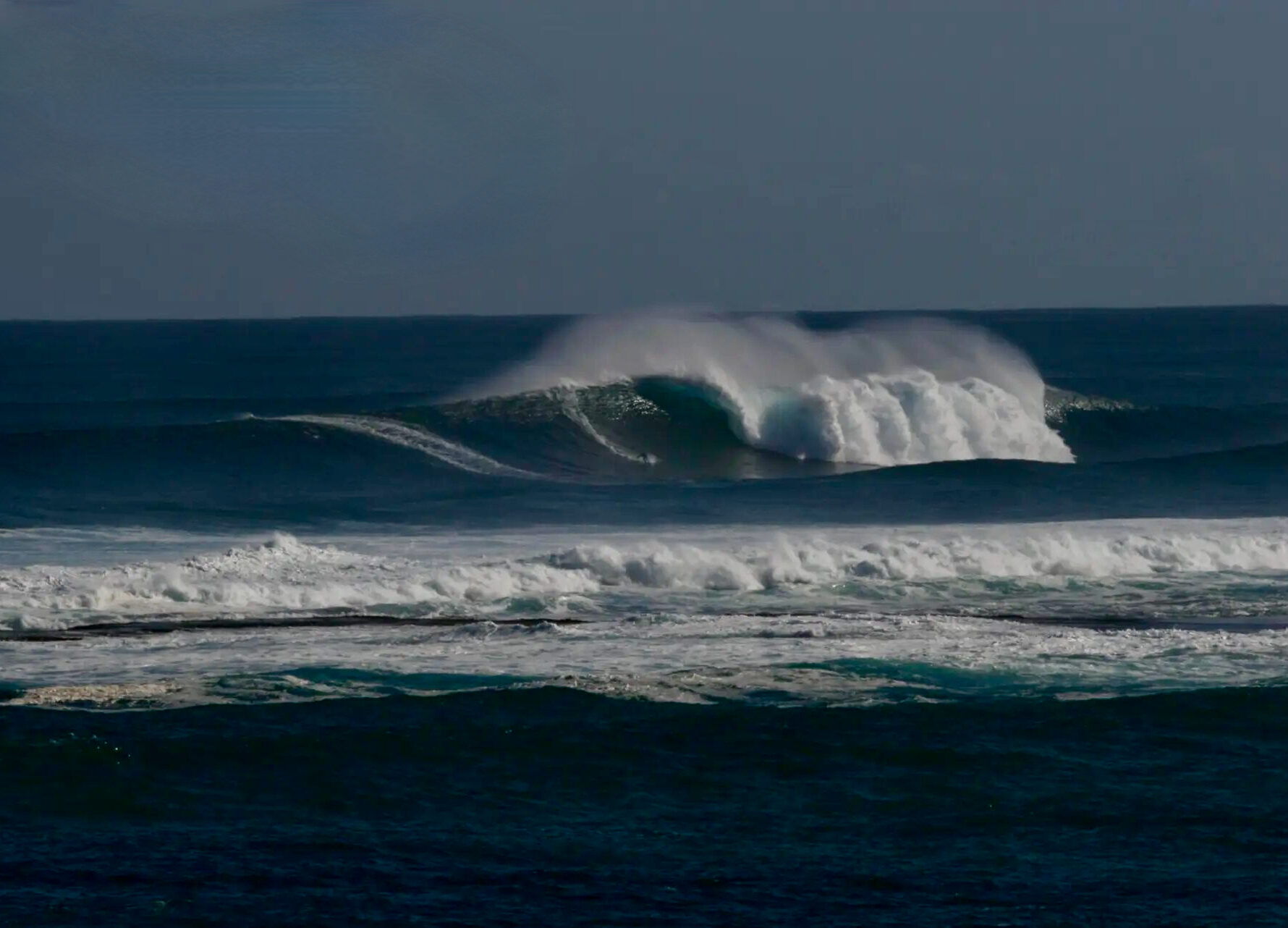 A surfer on a large wave off the coast